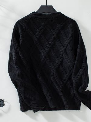 Black diamond cable knit crewneck sweater with ribbed cuffs and hem.