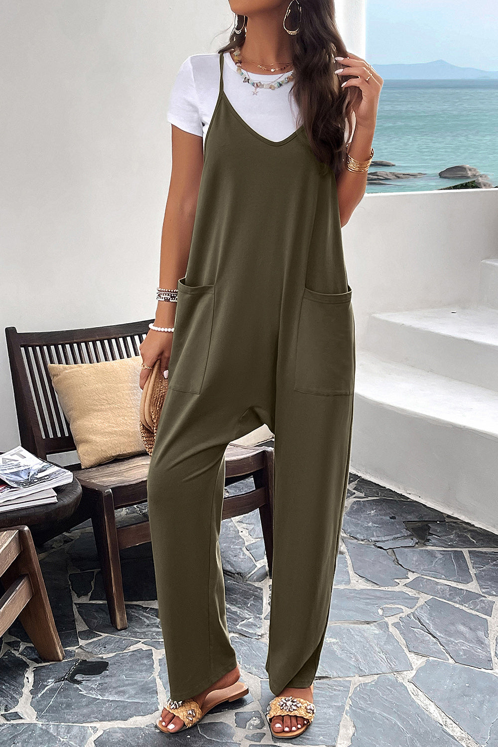 Army green relaxed drape pocket jumpsuit with V-neck and spaghetti straps.