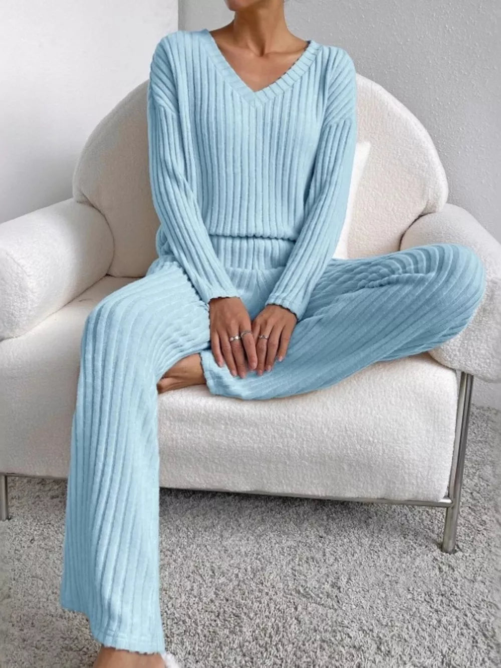 Blue ribbed knit V-neck loungewear set with long sleeves and wide-leg pants.