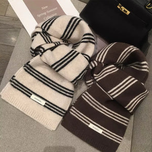 Contrast striped wool knit scarves in off-white and brown with black stripes.