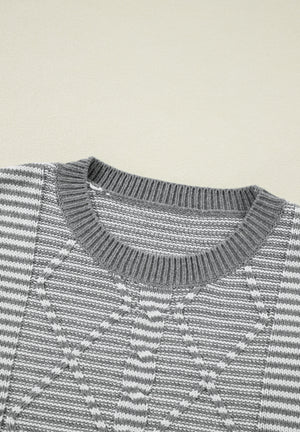 Gray and white geometric stripe knit sweater with crew neck.