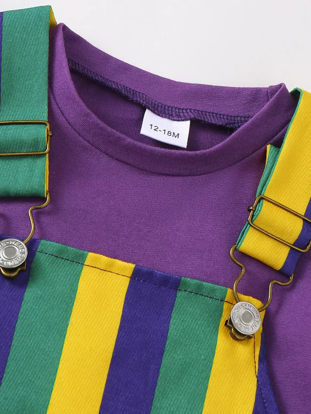 Baby overall dress and tee set with purple tee and striped overalls in green, yellow, and purple.