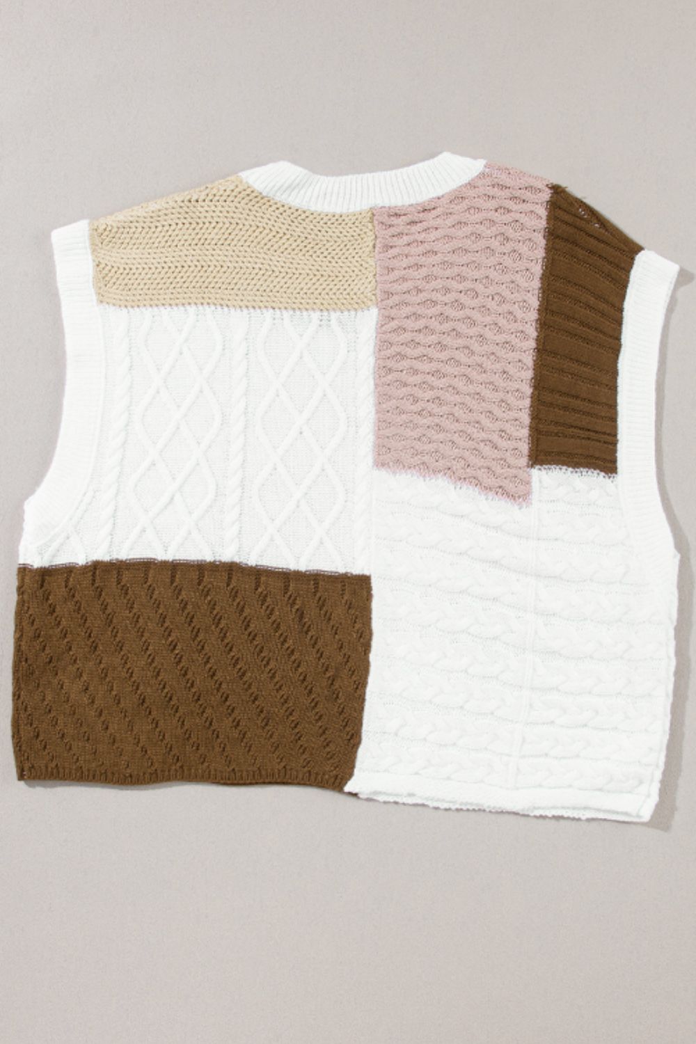 Patchwork cable knit tank top in white, dusty pink, brown, and tan acrylic with mixed stitch patterns.