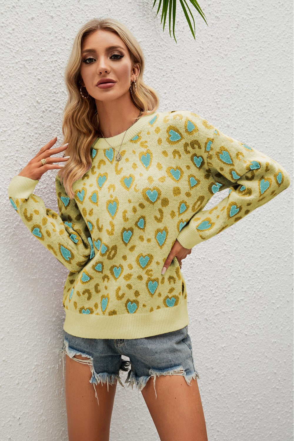 Light Yellow heart print drop shoulder sweater with crewneck and long sleeves.