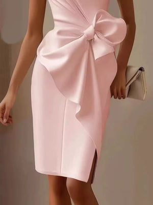 Sleeveless pink dress with a large bow detail and side slit.