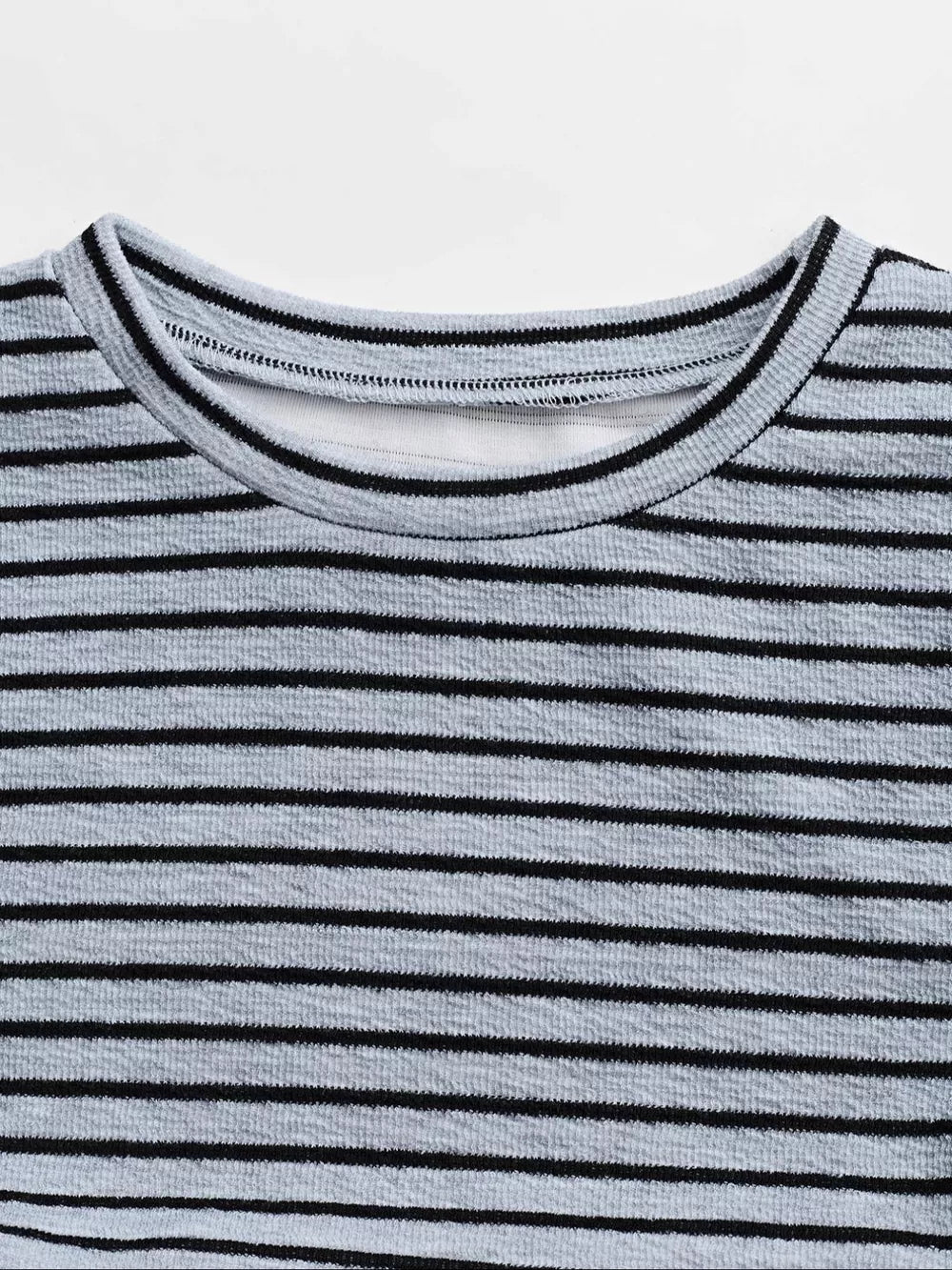 Striped crew neck crop top with textured fabric and black trim.