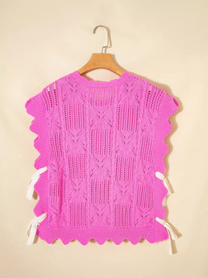 Chic openwork knit sweater vest in bright pink with cable knit pattern and adjustable white side ties.