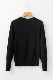 Black crewneck long sleeve knit top with subtle vertical seam detail.