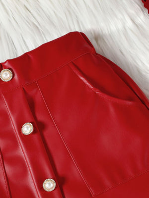 Red faux leather baby skirt with decorative pearl buttons and pocket detail