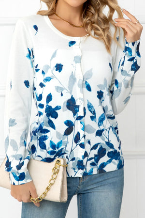 White crewneck cardigan with blue botanical print and button front.