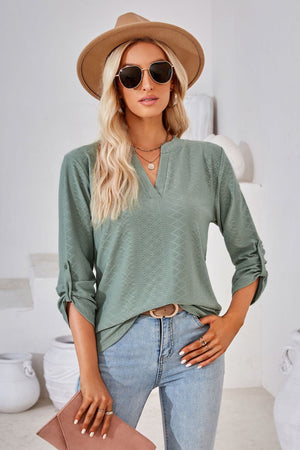 Sage textured henley blouse with rolled sleeves and v-neck.