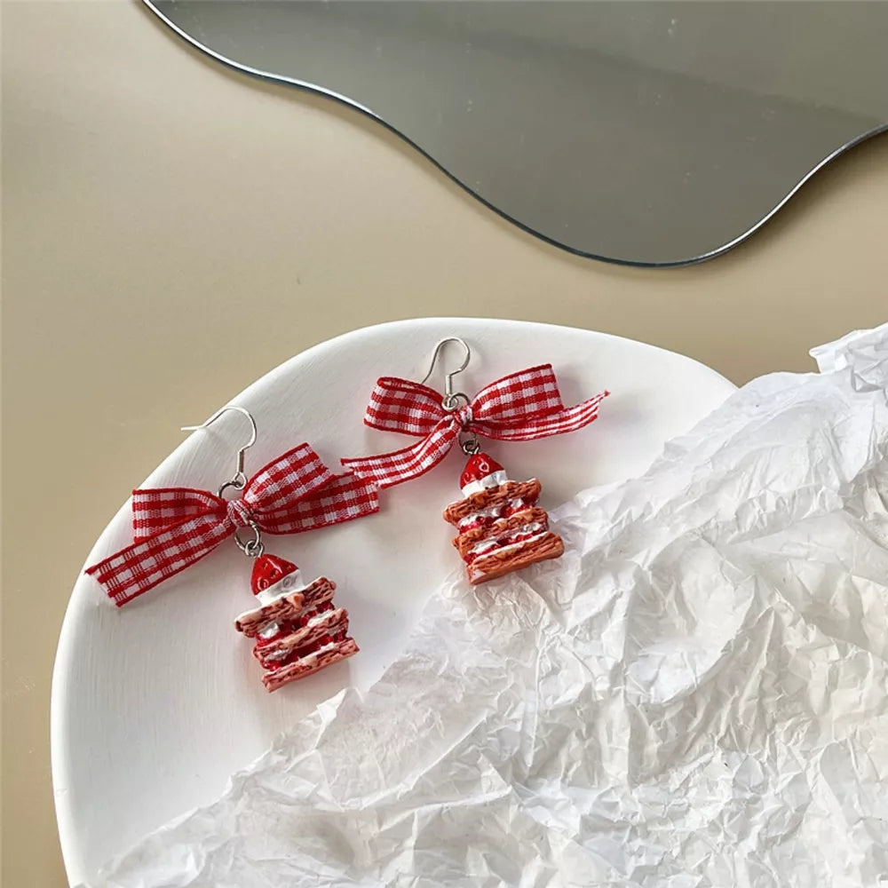 Charming strawberry dangle earrings with red checkered bow accents