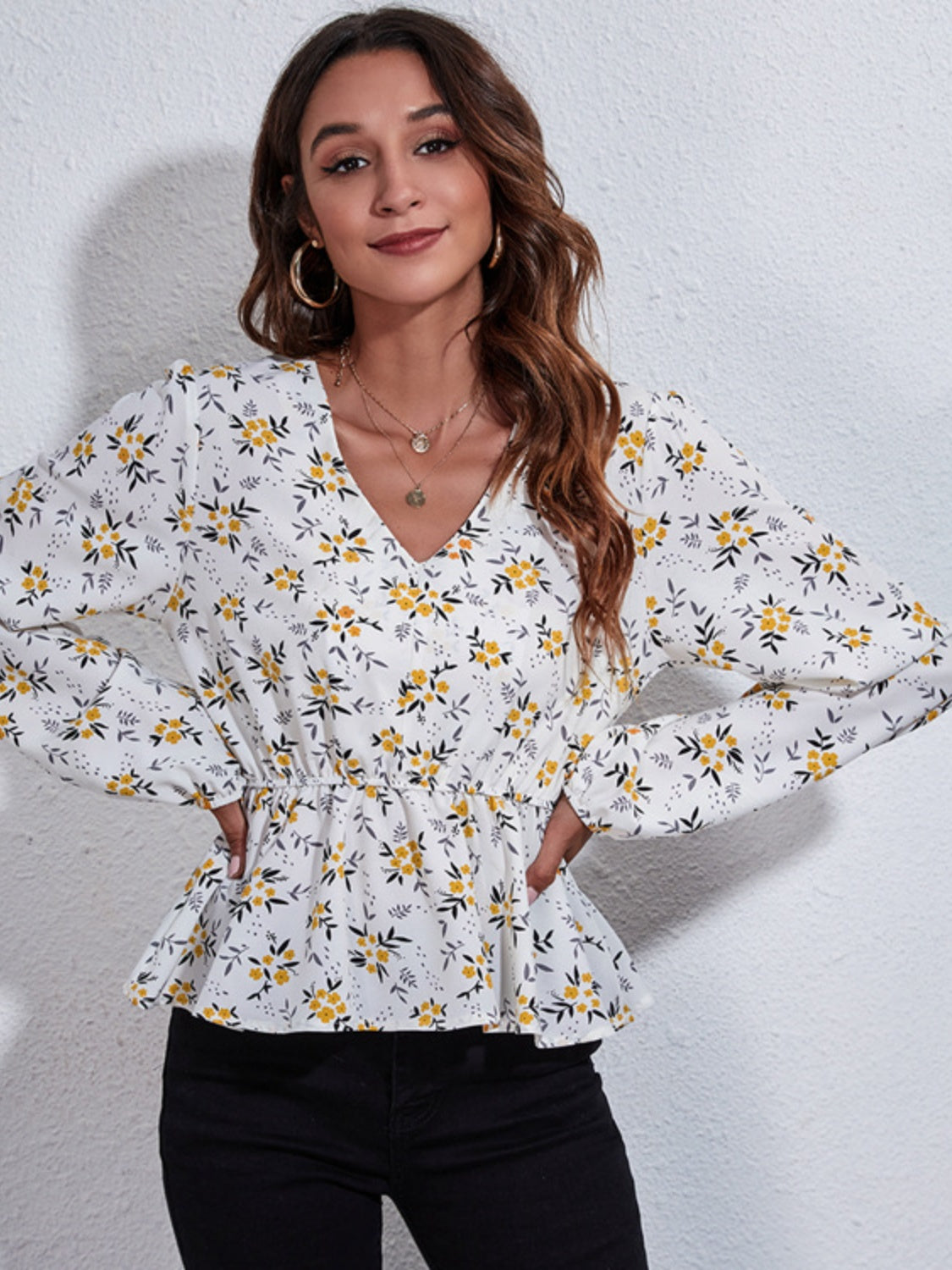 White floral peplum blouse with gathered waist and V-neck
