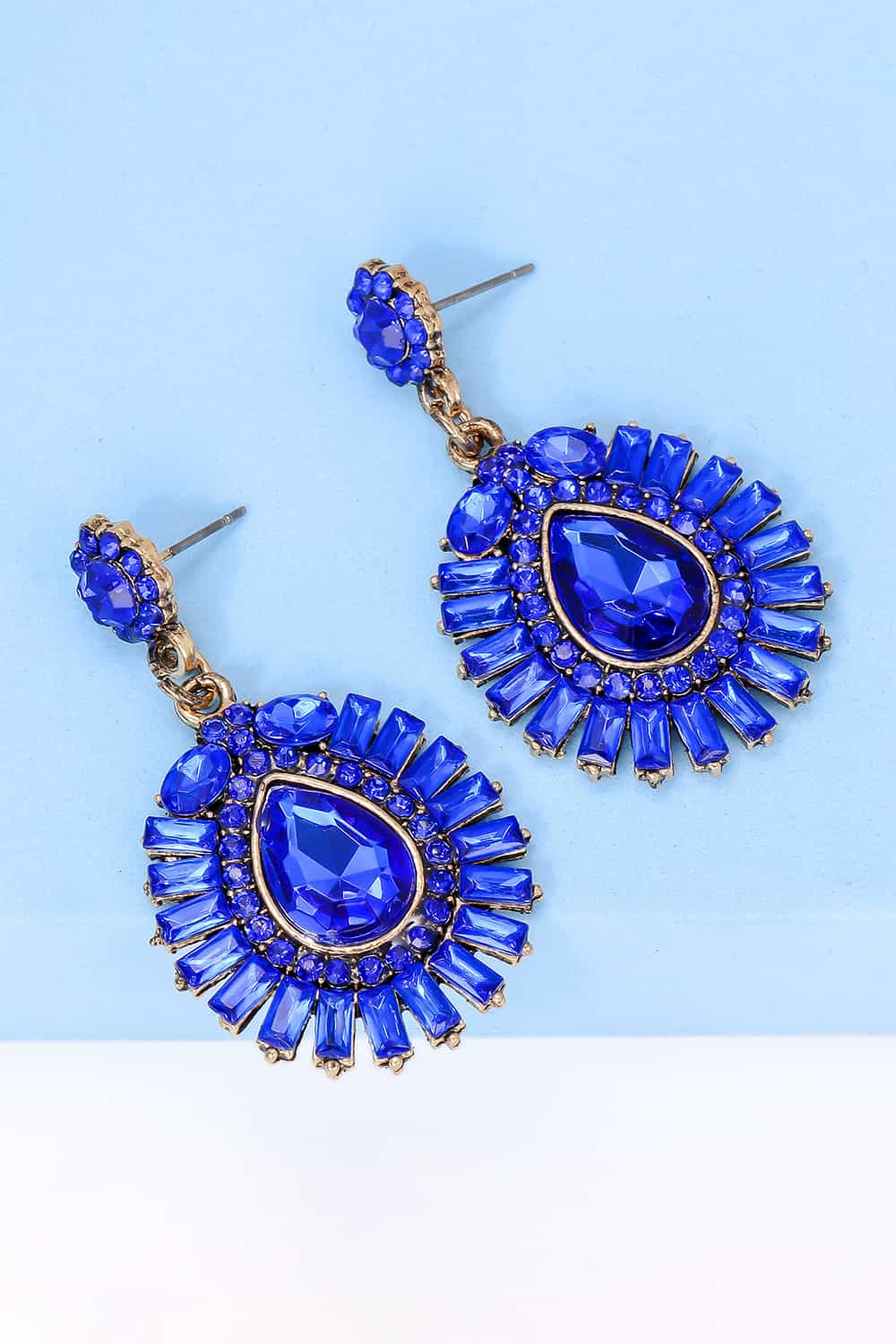 Royal blue gemstone burst dangle earrings with gold-tone settings.