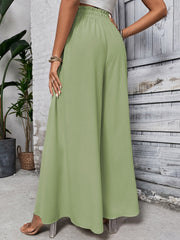 Light green ruffled waistline palazzo trousers with a wide leg.
