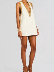 Glistening sequin mini dress with deep V-neck and gold trim, sleeveless.