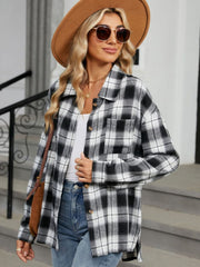 Black and white plaid collared long sleeve shirt with button front and chest pocket.