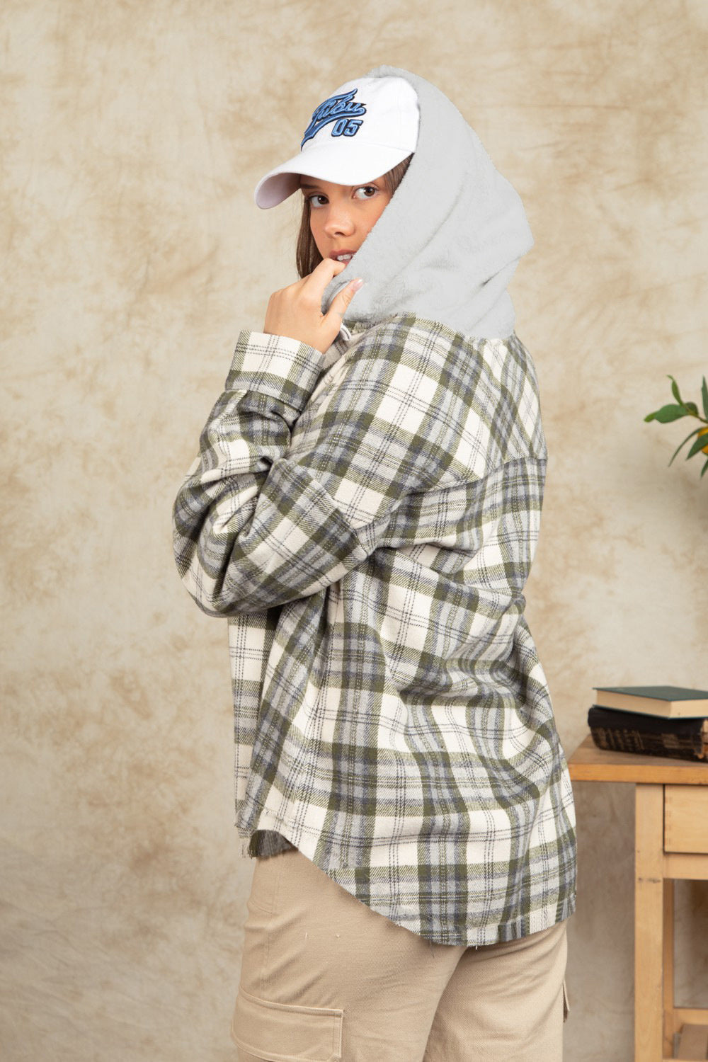 Cozy plaid shacket with sherpa hood in green and white, buttoned, casual style.