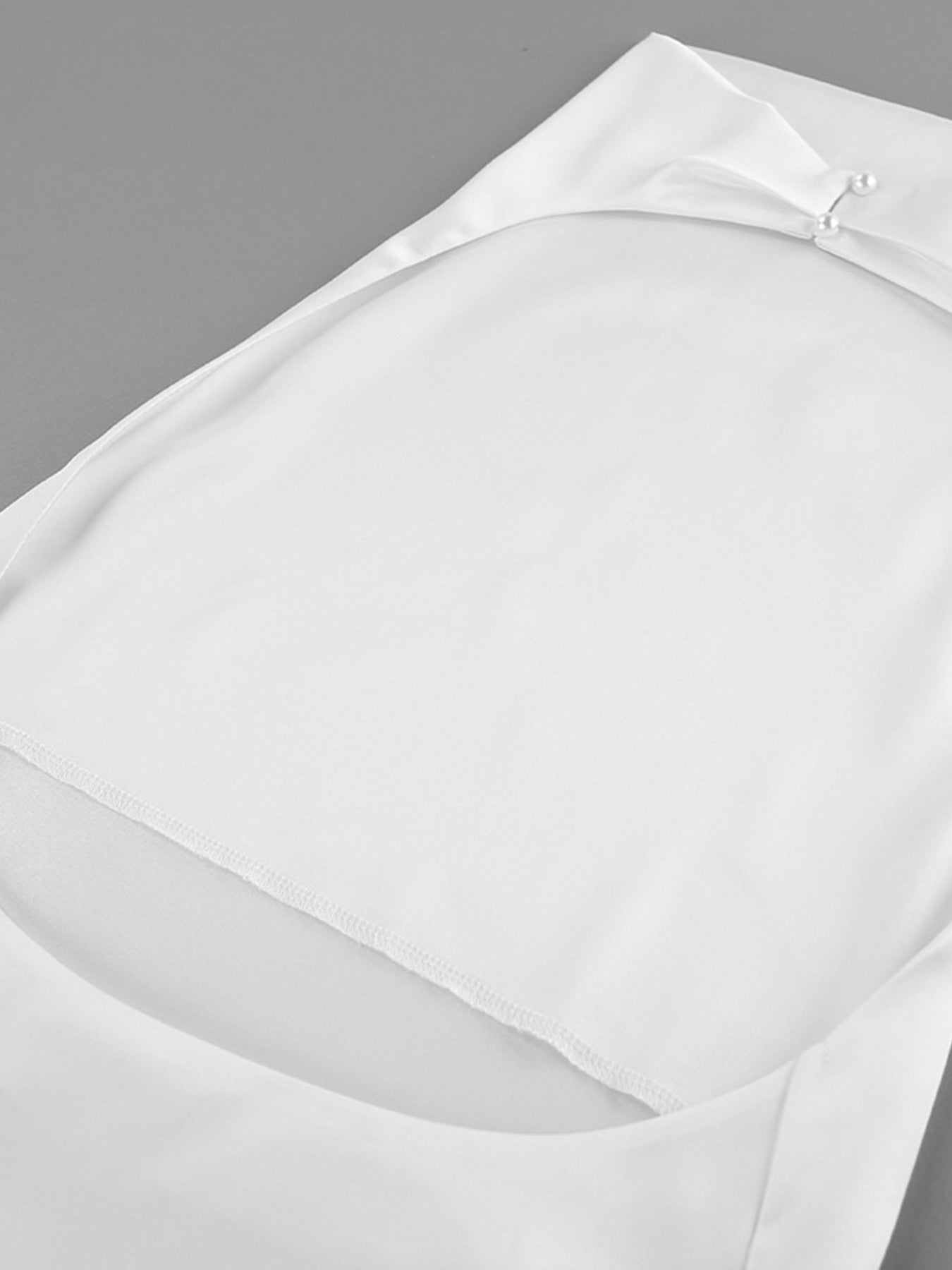 White satin halter neck cami top with cowl neckline and pearl button detail
