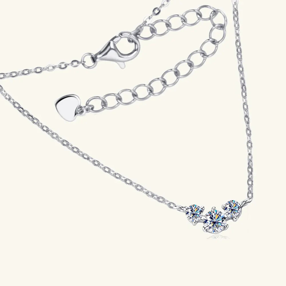 Silver moissanite cluster pendant necklace with adjustable chain and heart charm.