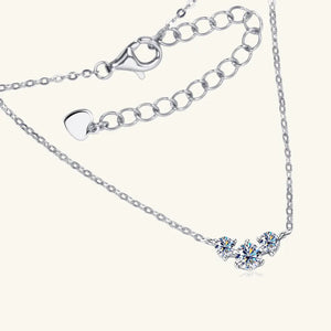 Silver moissanite cluster pendant necklace with adjustable chain and heart charm.