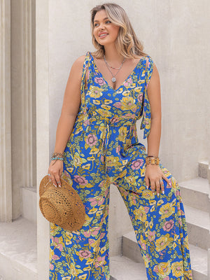 Blue floral tie-shoulder wide-leg jumpsuit with V-neck and drawstring waist.