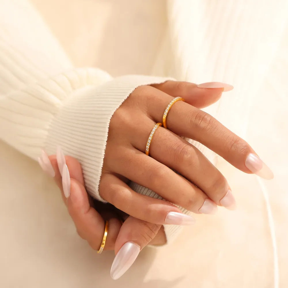 Gold pavé band stacking ring set with cubic zirconia accents.