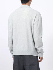 Men's light gray textured knit polo with long sleeves and a classic collar.