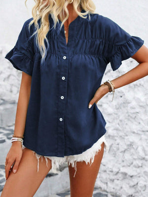 Navy blue button-up blouse with gathered yoke and ruffle sleeves.