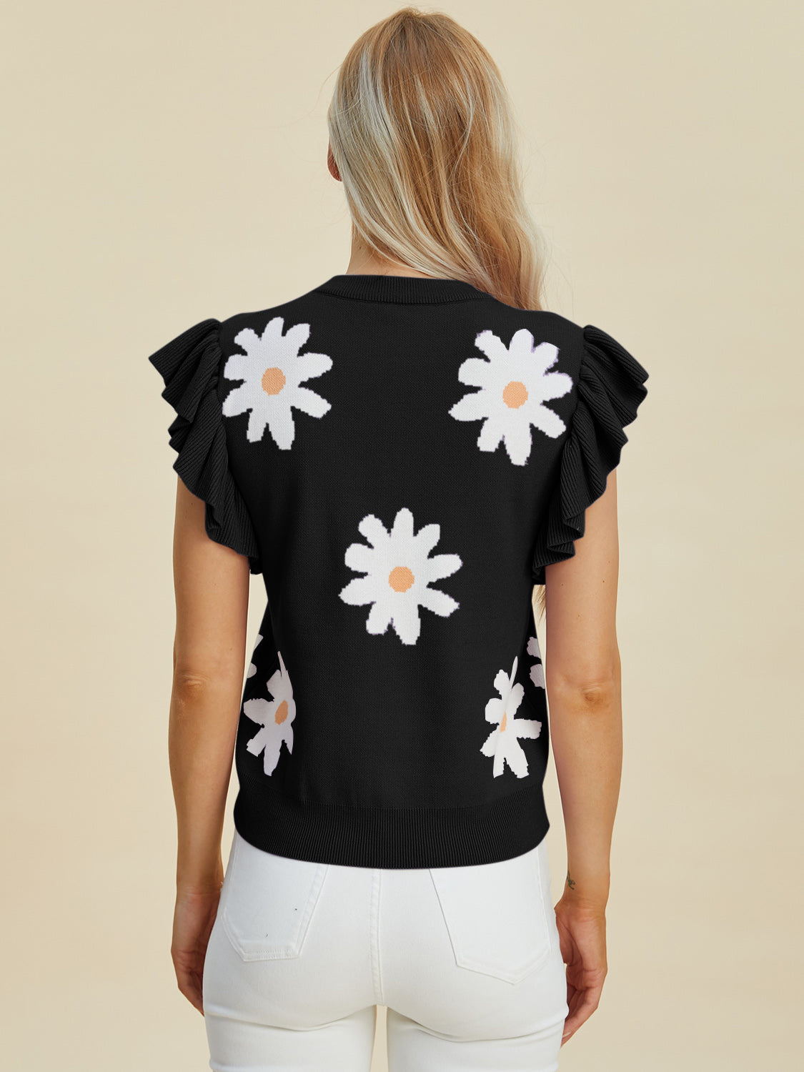 Black knit blouse with white daisy print and ruffled cap sleeves.