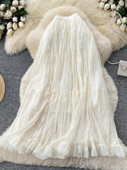 Elegant tiered tulle skirt in apricot with ruffled hem and lining.