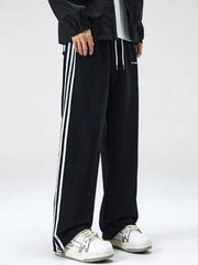 Black cotton sweatpants with white side stripes and drawstring waist.