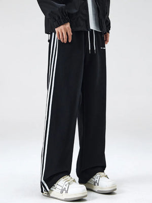 Black cotton sweatpants with white side stripes and drawstring waist.
