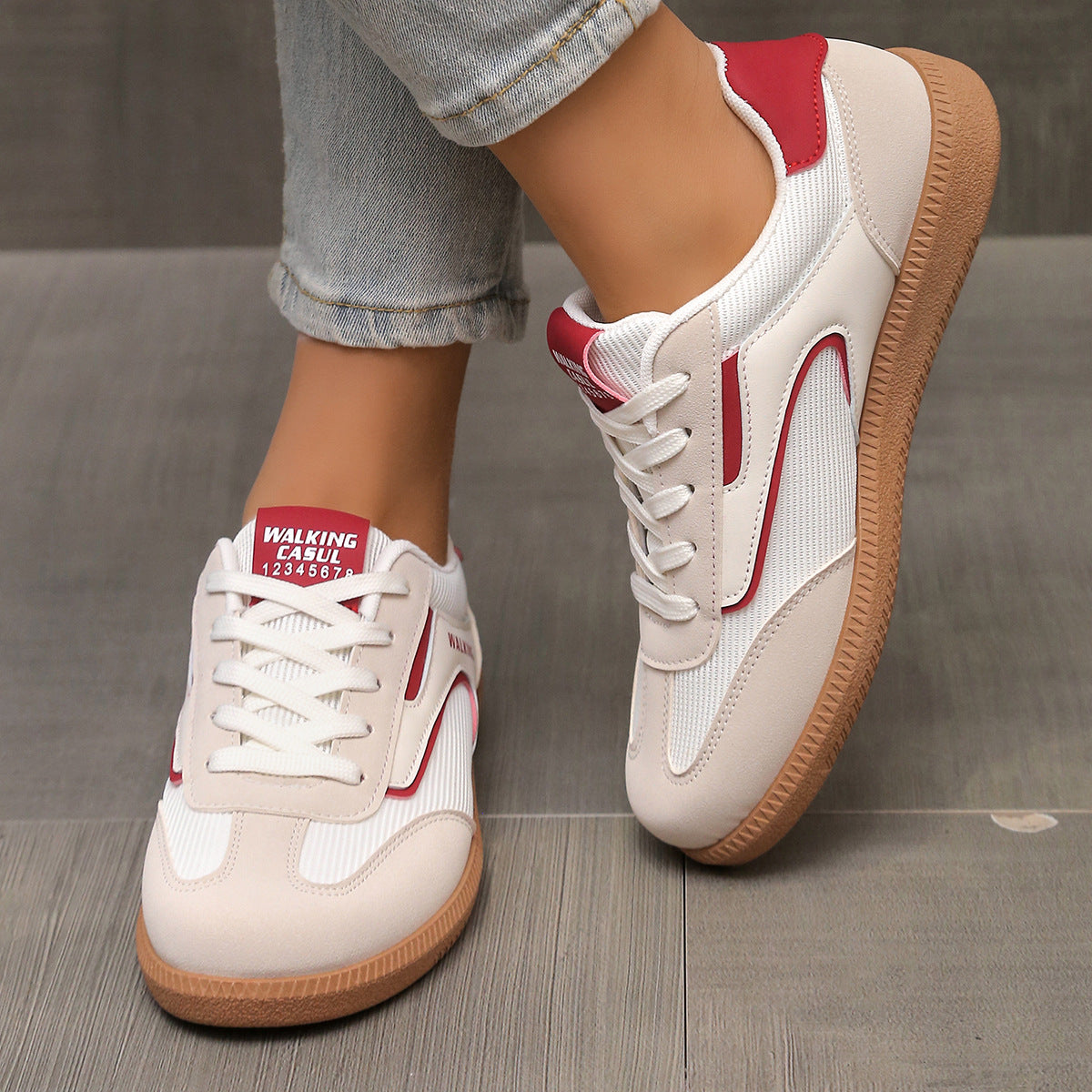 Cream and red lace-up sneakers with white mesh panels and a brown sole.