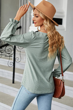 Light Green textured puff sleeve blouse with ruffled cuffs.