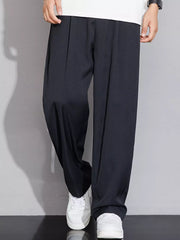 Men's black wide-leg chinos with a relaxed fit and subtle pleats.