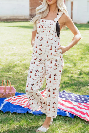 Desert motif cotton overalls with cropped legs and adjustable straps.