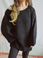 Black oversized ribbed knit sweater with a dropped shoulder and wide sleeves.