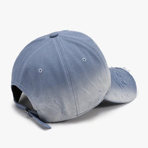 Distressed light blue denim baseball cap with ombre fading and frayed details.