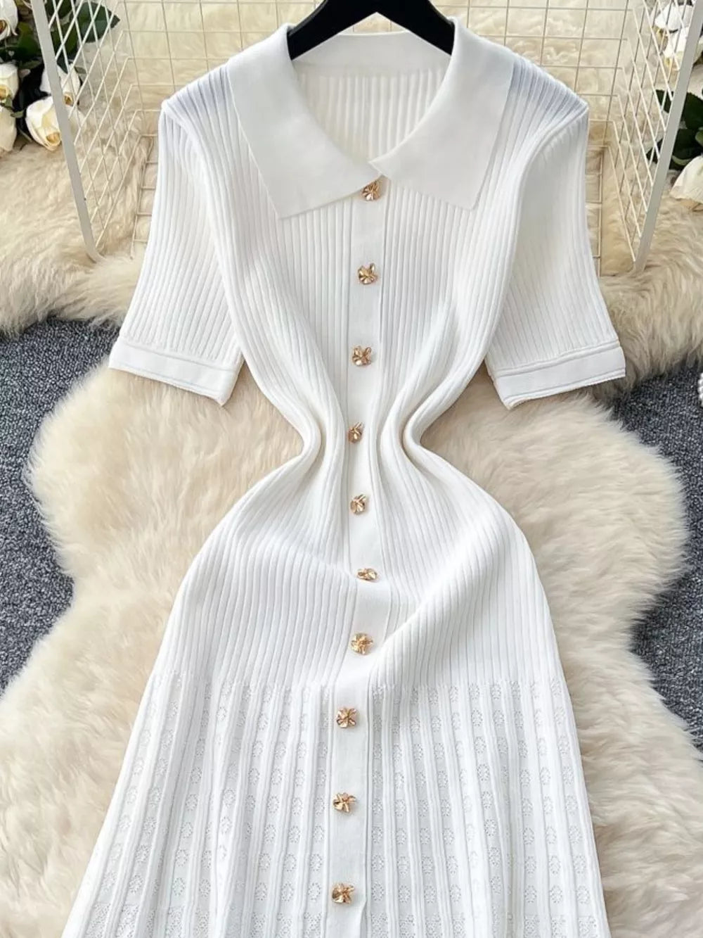 White knit Peter Pan collar dress with gold flower buttons and short sleeves.