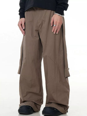 Earthy brown wide-leg cargo pants with buttoned flap pockets and full swing cut.