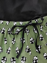 Green panda print pajama shorts with drawstring and black top detail.