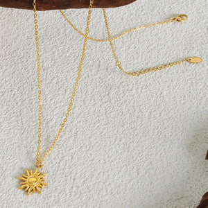 Gold sunburst pendant necklace with adjustable chain, 18K gold-plated.