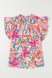 Floral blouse with flutter sleeves and a tie-neck, featuring a vibrant abstract floral print.
