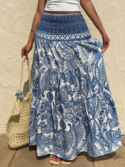 Bohemian maxi skirt in Royal Blue with white paisley print, tiered hem, and smocked waist.