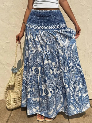 Bohemian maxi skirt in Royal Blue with white paisley print, tiered hem, and smocked waist.