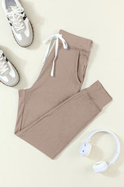 Mocha slim-fit lounge joggers with white drawstring and cuffed ankles.