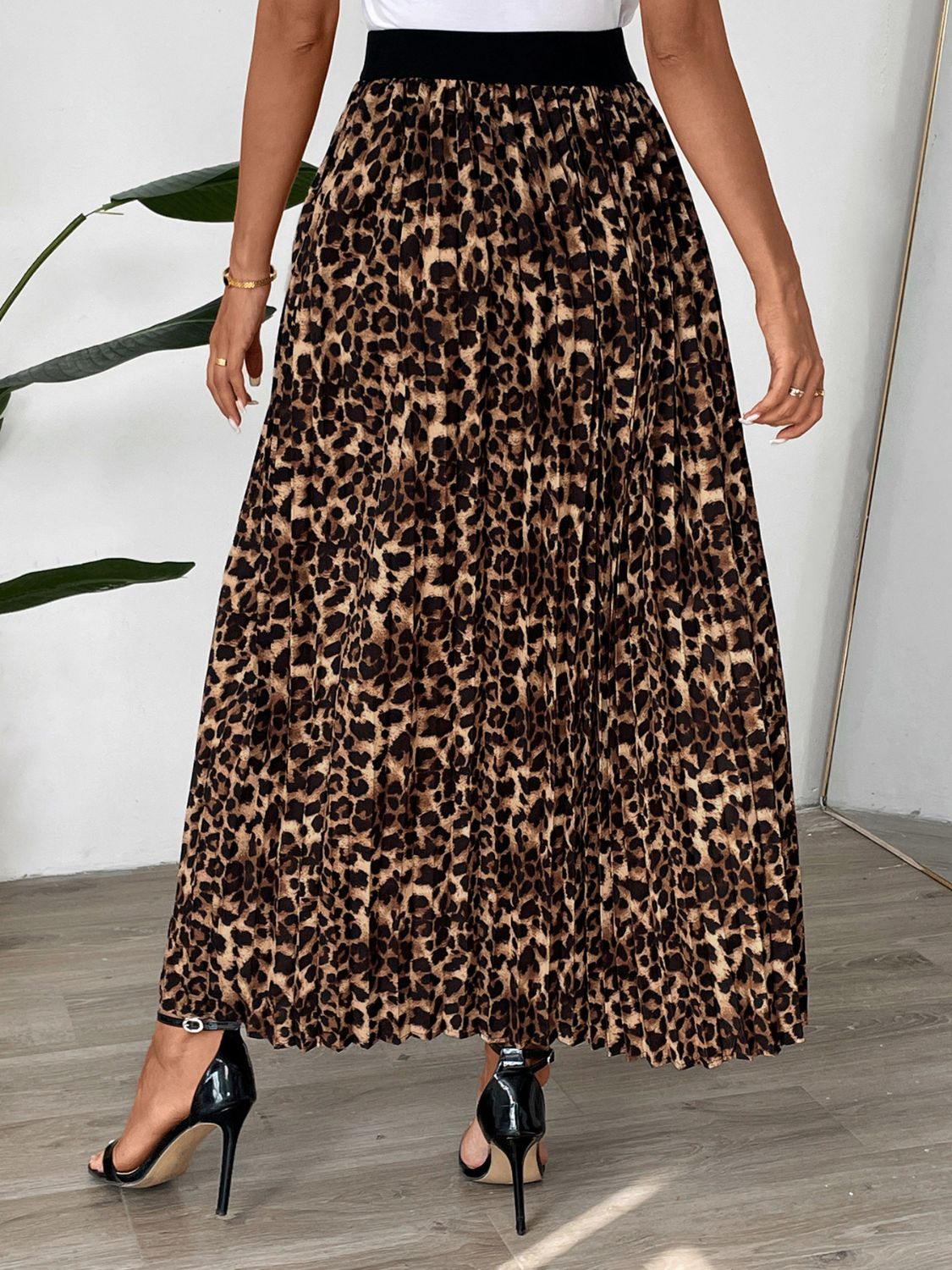 Leopard print maxi skirt with knife pleats and a black waistband.