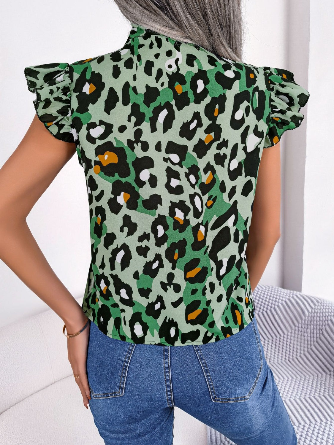 Green leopard print blouse with ruffled sleeves and mock neck