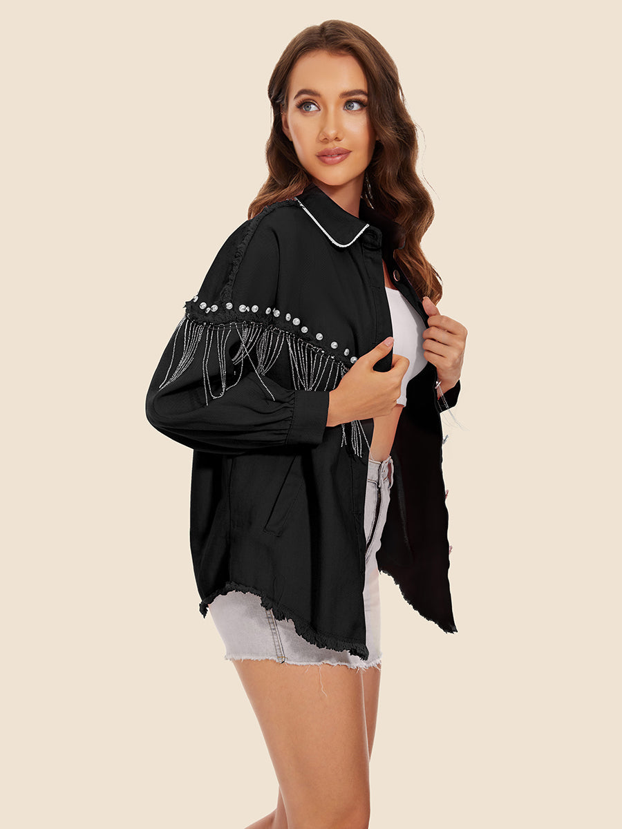 Black denim trucker jacket with pearl and fringe embellishments on sleeves and frayed hem